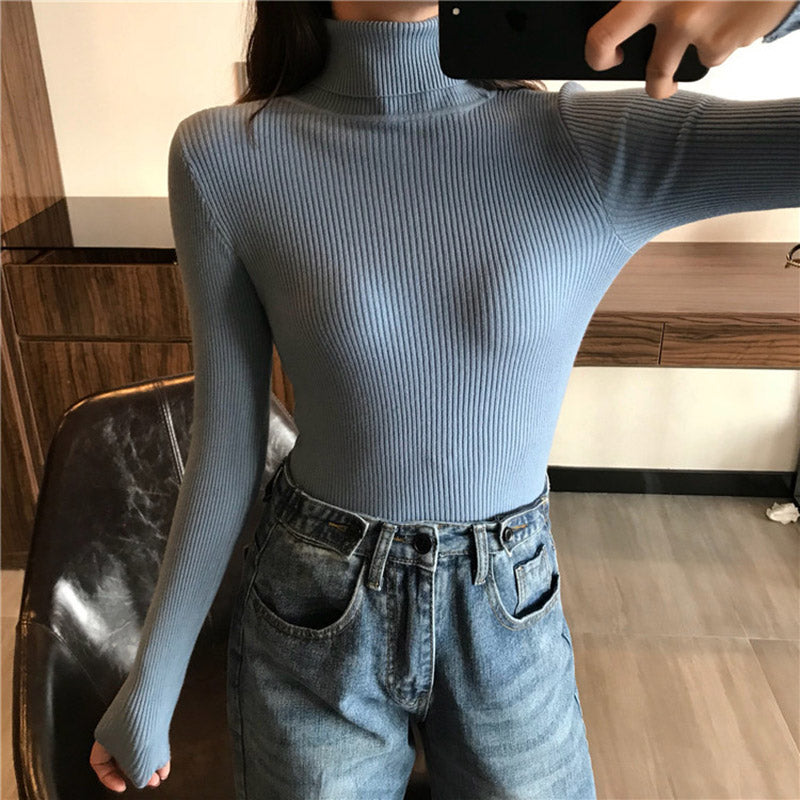 A light blue ribbed knit turtleneck top with long sleeves