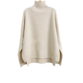 Cream-colored, ribbed-knit turtleneck sweater with a loose fit and side slits