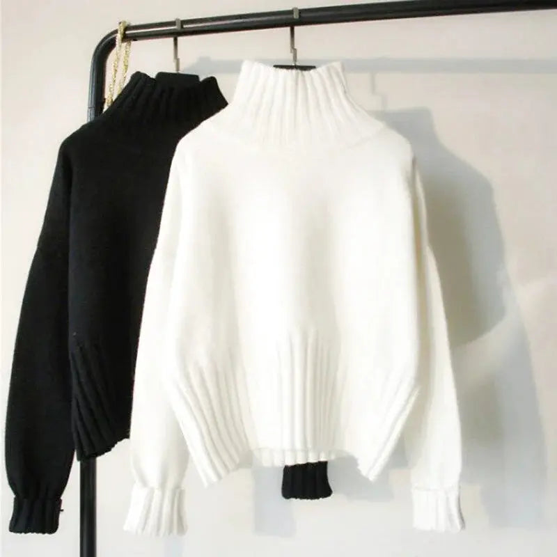 White high-neck knit sweater with ribbed cuffs and a soft, textured fabric