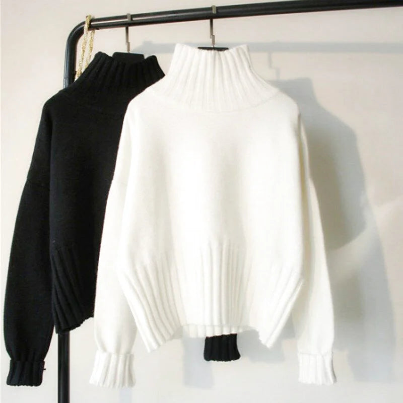 White high-neck knit sweater with ribbed cuffs and a soft, textured fabric