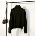 Black ribbed turtleneck sweater with long sleeves and a cropped hem