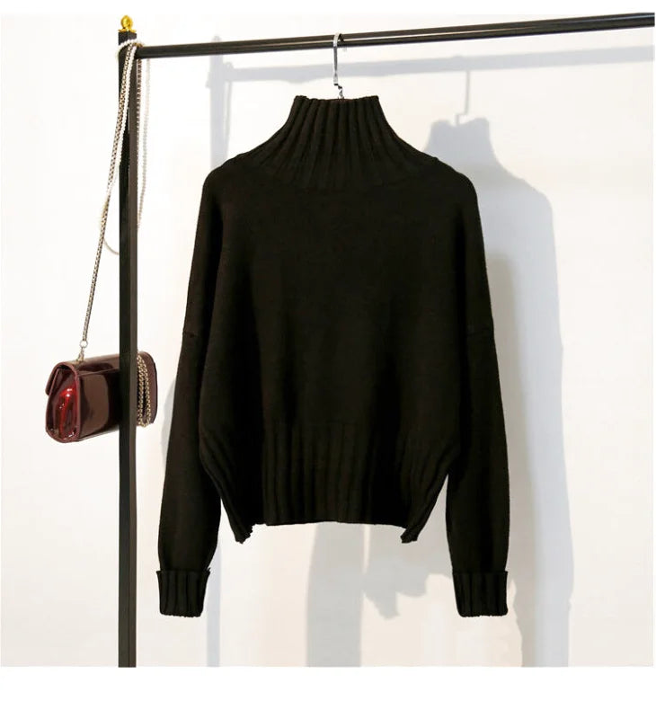 Black ribbed turtleneck sweater with long sleeves and a cropped hem