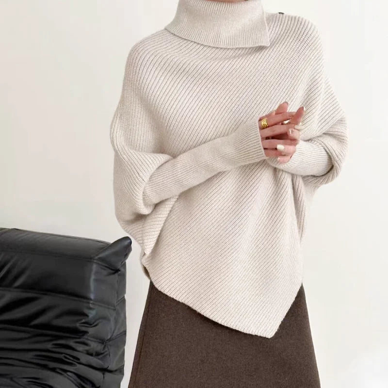 A cozy off-white ribbed knit turtleneck sweater with a relaxed, oversized fit
