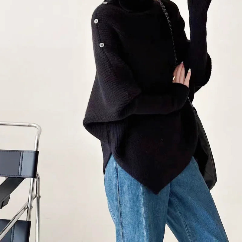 Black oversized knit sweater with button detailing on the sleeve