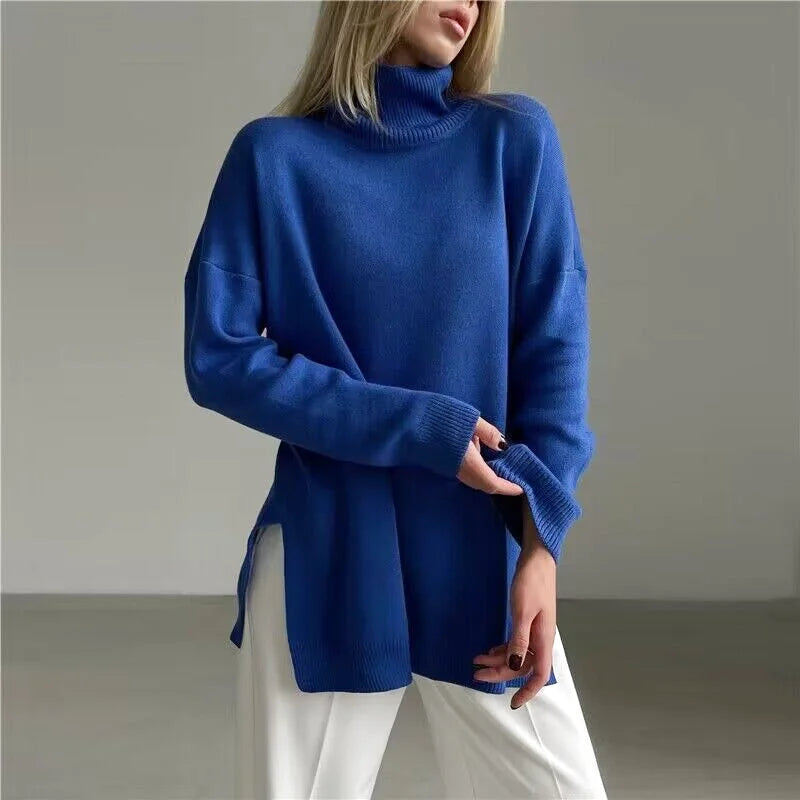 A vibrant royal blue, oversized turtleneck sweater with a soft knit texture and slightly asymmetrical hemline
