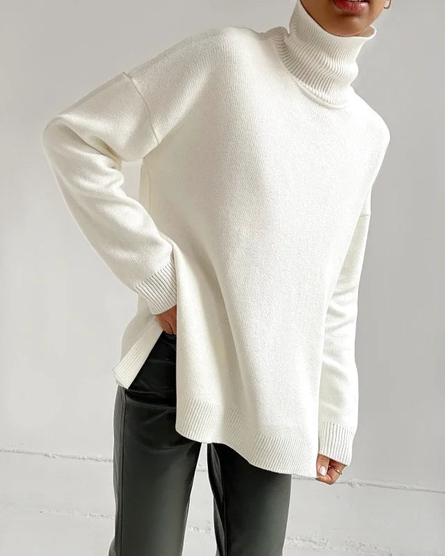 A cozy, off-white turtleneck sweater with a soft knit texture and ribbed cuffs