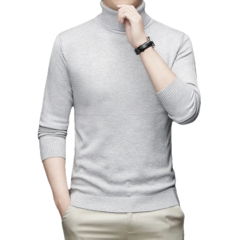 A light gray, long-sleeved turtleneck sweater with ribbed cuffs and hem