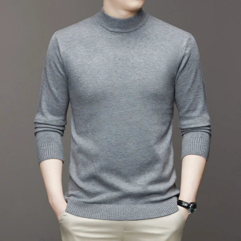A sleek, heather gray turtleneck sweater with ribbed cuffs and hem