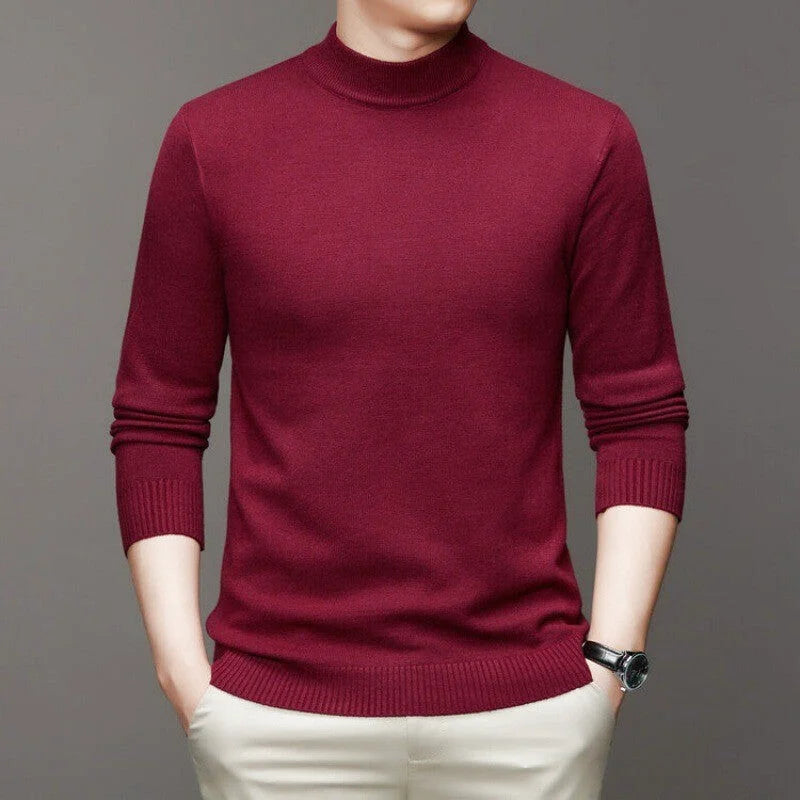 A rich burgundy turtleneck sweater with a smooth knit texture and ribbed cuffs and hem