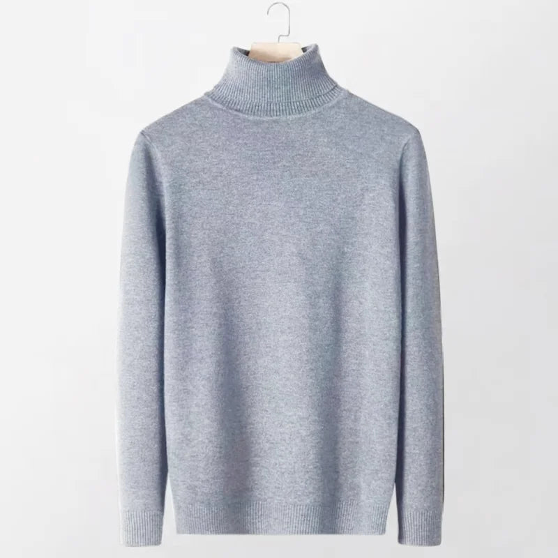 A light gray, finely knitted turtleneck sweater with a ribbed collar and cuffs