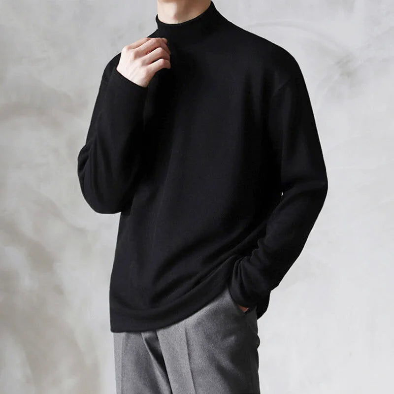 Black, long-sleeved turtleneck sweater with a smooth, soft texture