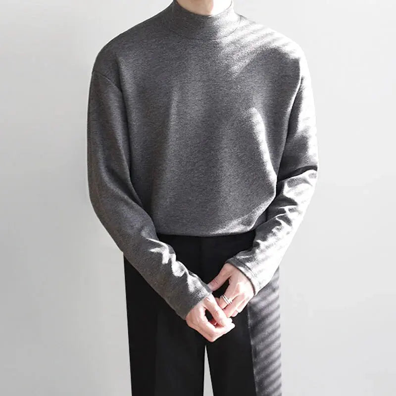 A soft, heather gray long-sleeved turtleneck sweater with a relaxed fit