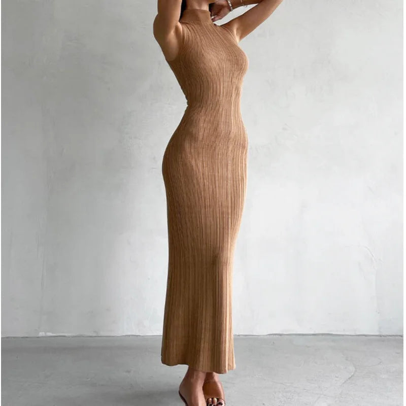 A sleek, ribbed tan knit maxi dress with a high neckline and sleeveless design