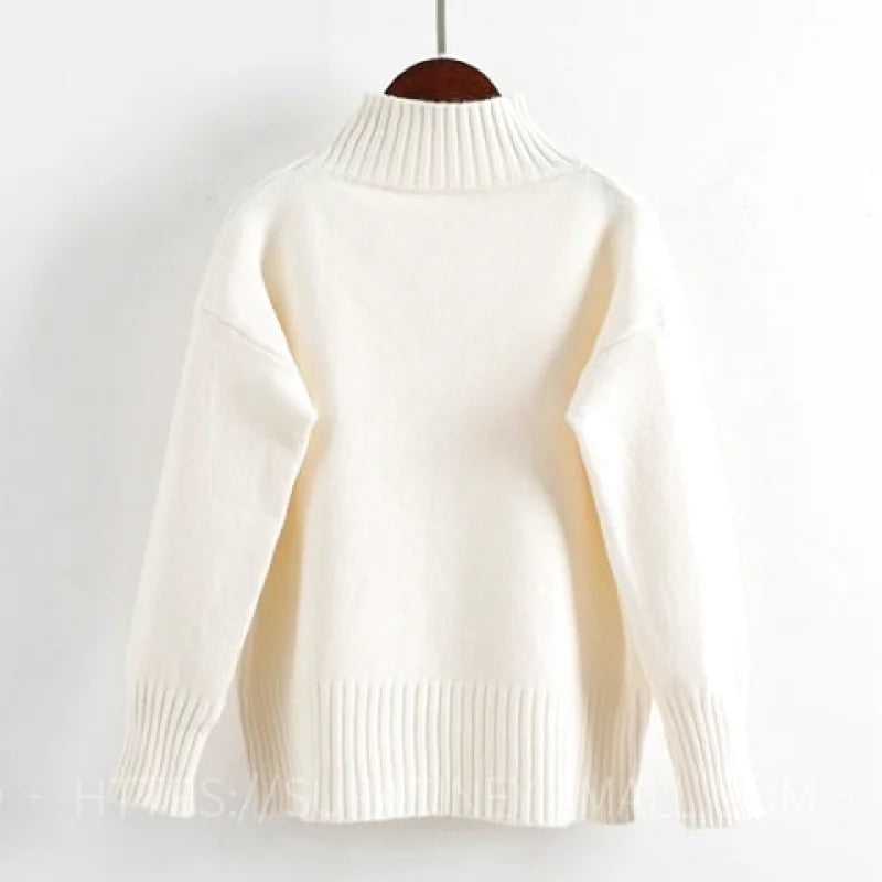 Cream-colored, ribbed-knit turtleneck sweater with long sleeves and a soft, cozy texture