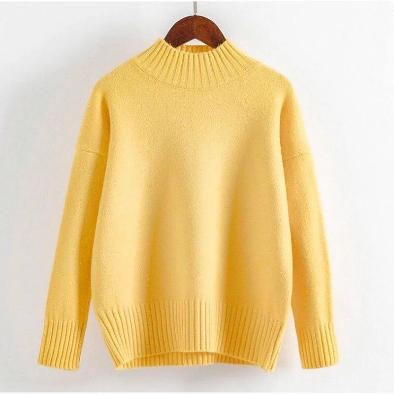 A soft, mustard-yellow knit sweater with a ribbed crew neckline and cuffs