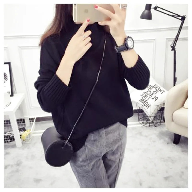 Black cylindrical crossbody bag with a sleek, minimalist design and a thin strap