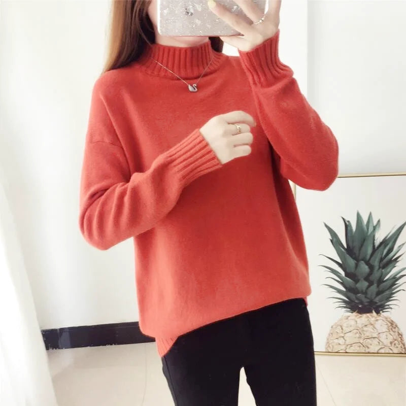 A cozy coral-colored turtleneck sweater with ribbed cuffs and neckline
