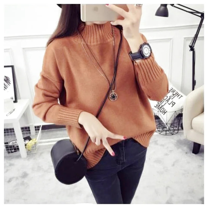 A cozy, rust-colored turtleneck sweater with ribbed cuffs and hem