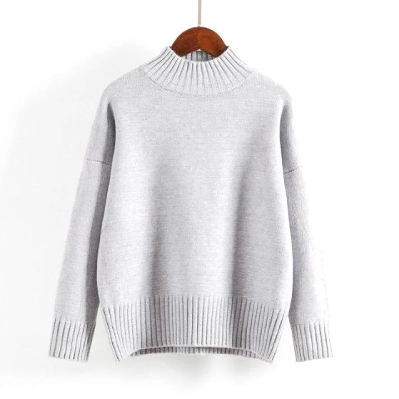 A soft, heather gray knit sweater with a ribbed turtleneck and cuffs