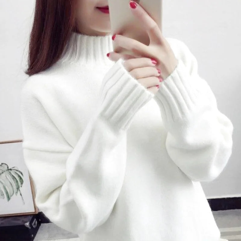 White high-neck knit sweater with ribbed cuffs and a soft, cozy texture