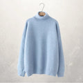 A soft, light blue turtleneck sweater with a cozy knit texture and relaxed fit