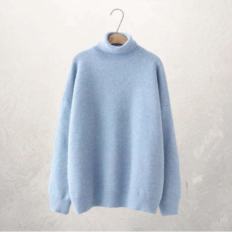 A soft, light blue turtleneck sweater with a cozy knit texture and relaxed fit