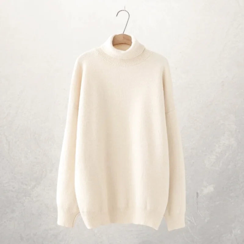 Cream-colored, soft-knit turtleneck sweater with a subtle textured pattern around the neckline