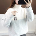 A cozy, two-tone fluffy sweater in soft white and light blue with a cute embroidered mouse detail on the chest