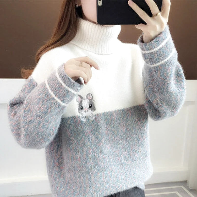A cozy, two-tone turtleneck sweater in soft white and heather gray with a cute embroidered mouse on the chest