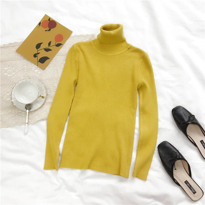 A mustard-yellow ribbed knit turtleneck sweater