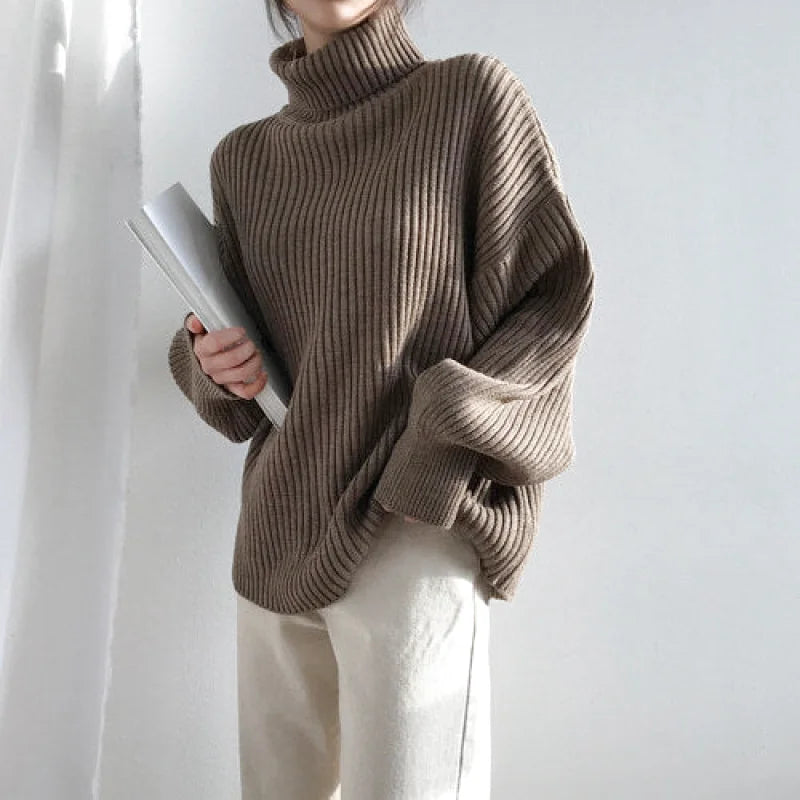 A cozy, ribbed-knit turtleneck sweater in a warm taupe hue