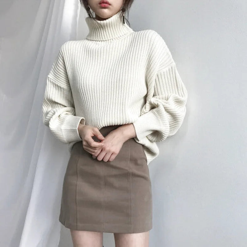 Cream-colored ribbed knit turtleneck sweater with voluminous sleeves