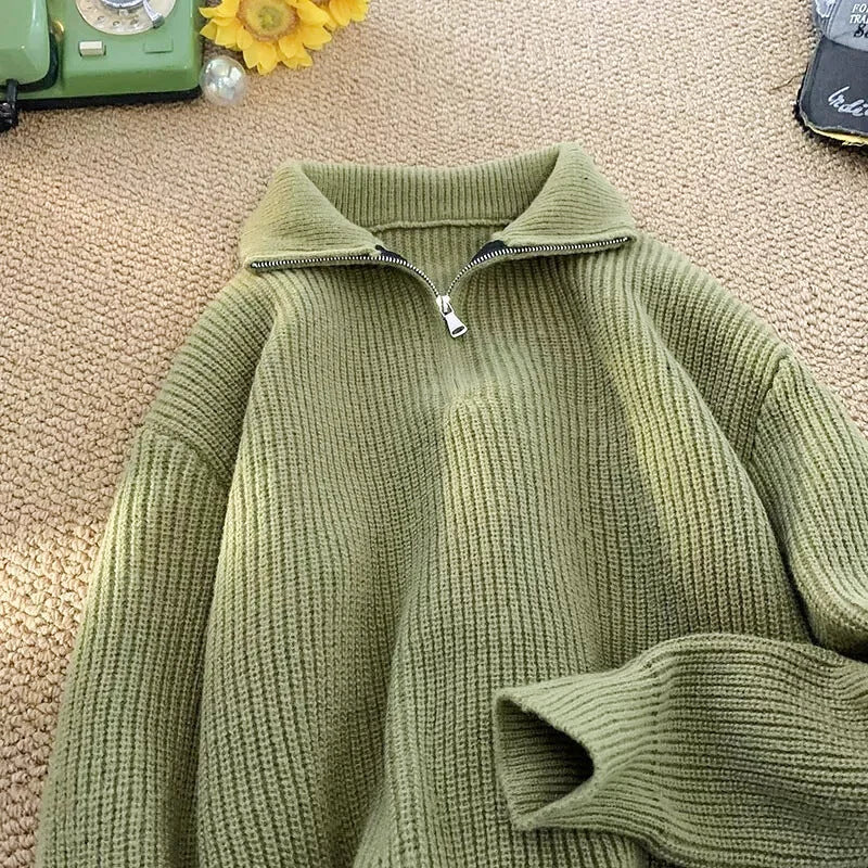 Olive green ribbed knit sweater with a half-zip collar and silver zipper