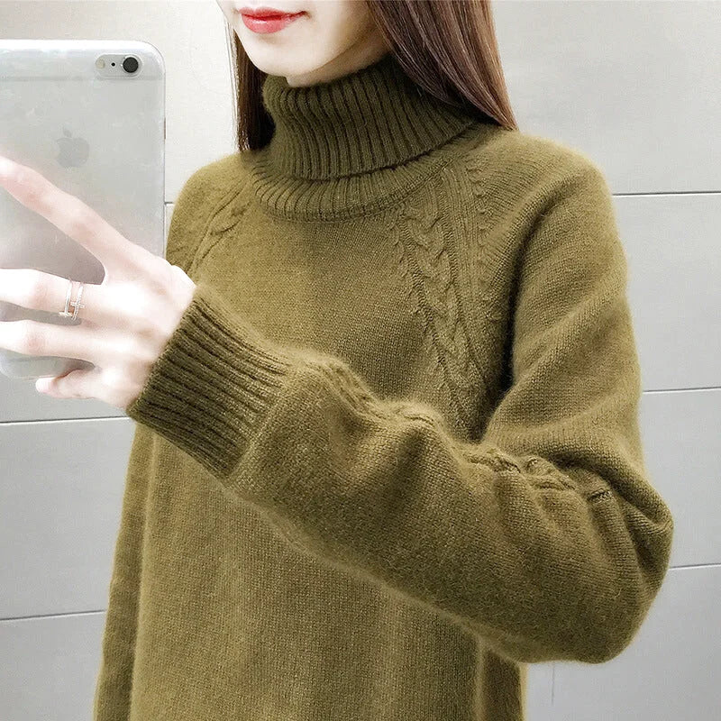 Olive green turtleneck sweater with cable knit detailing on the shoulders and ribbed cuffs