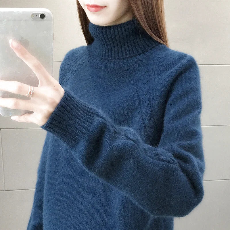 A cozy navy blue turtleneck sweater with a textured knit pattern and ribbed cuffs