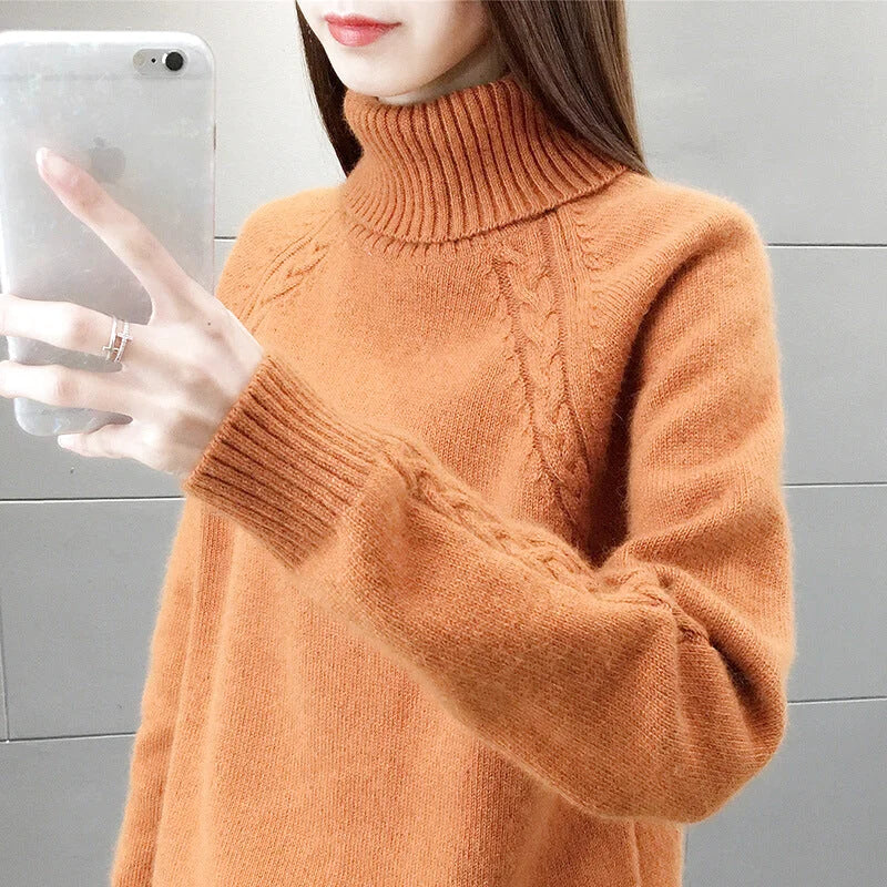 Warm orange turtleneck sweater with a textured cable-knit pattern and ribbed cuffs