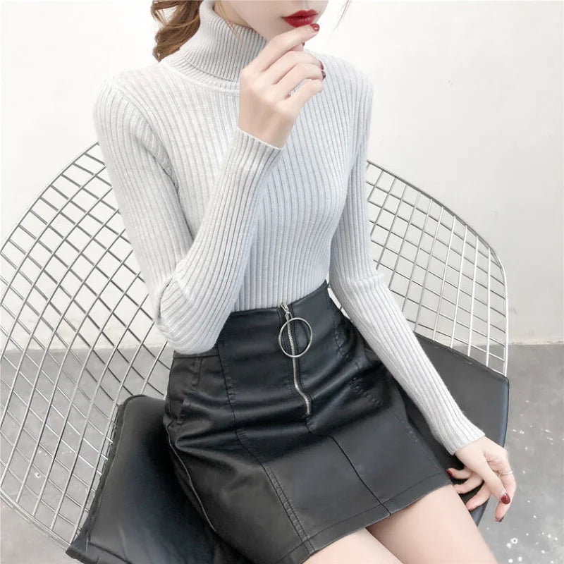 A light gray ribbed knit turtleneck sweater with long sleeves
