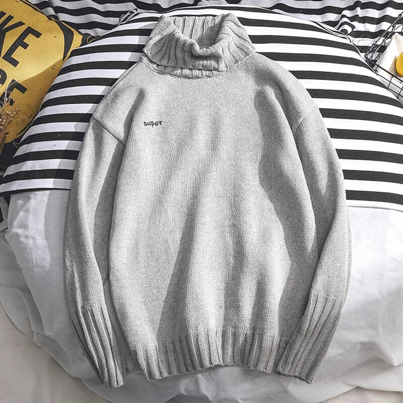 A soft, heather gray turtleneck sweater with a ribbed knit collar and cuffs