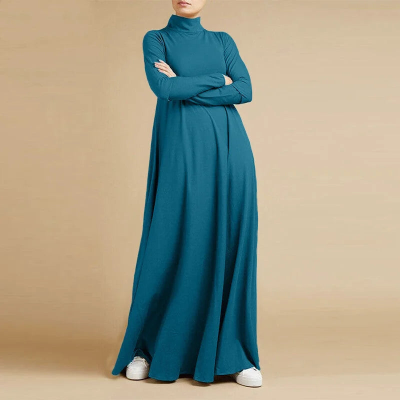 A teal, long-sleeved, high-neck maxi dress with a flowing silhouette