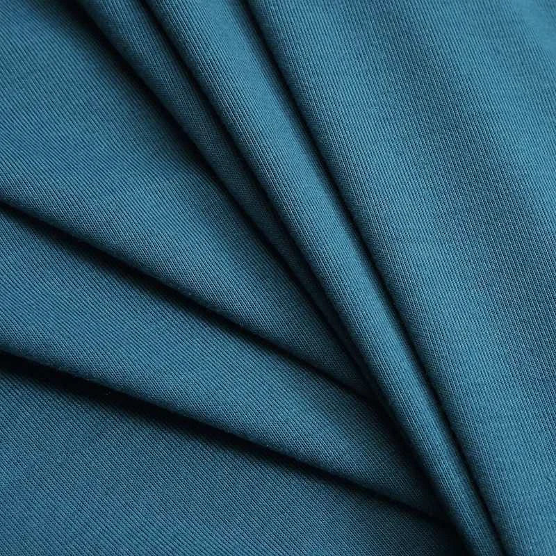 Teal-colored ribbed knit fabric with a smooth, slightly textured surface