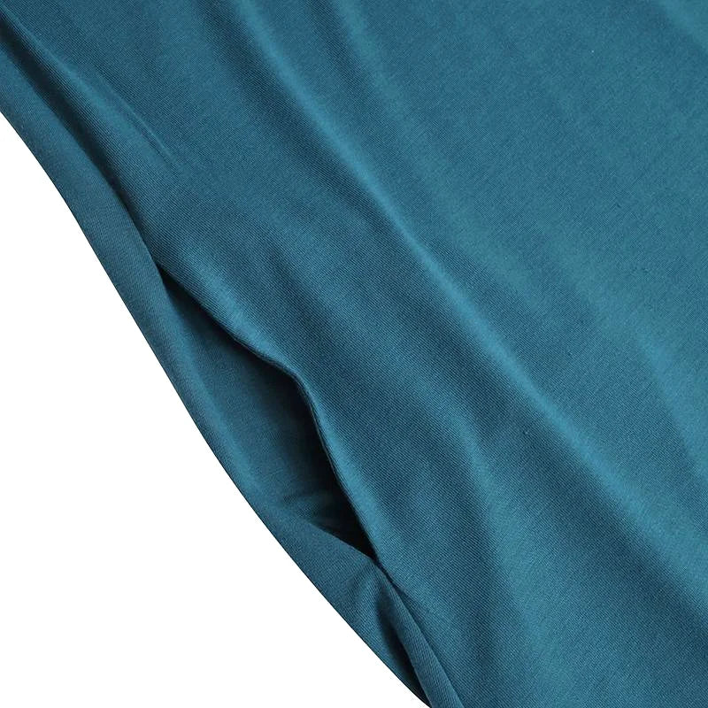 Teal-colored, soft knit fabric with a subtle ribbed texture