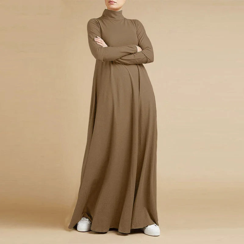 A flowing, long-sleeved, high-necked brown maxi dress made of soft fabric